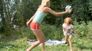 Curly redhead and blonde teen babes drilled outdoors standing up
